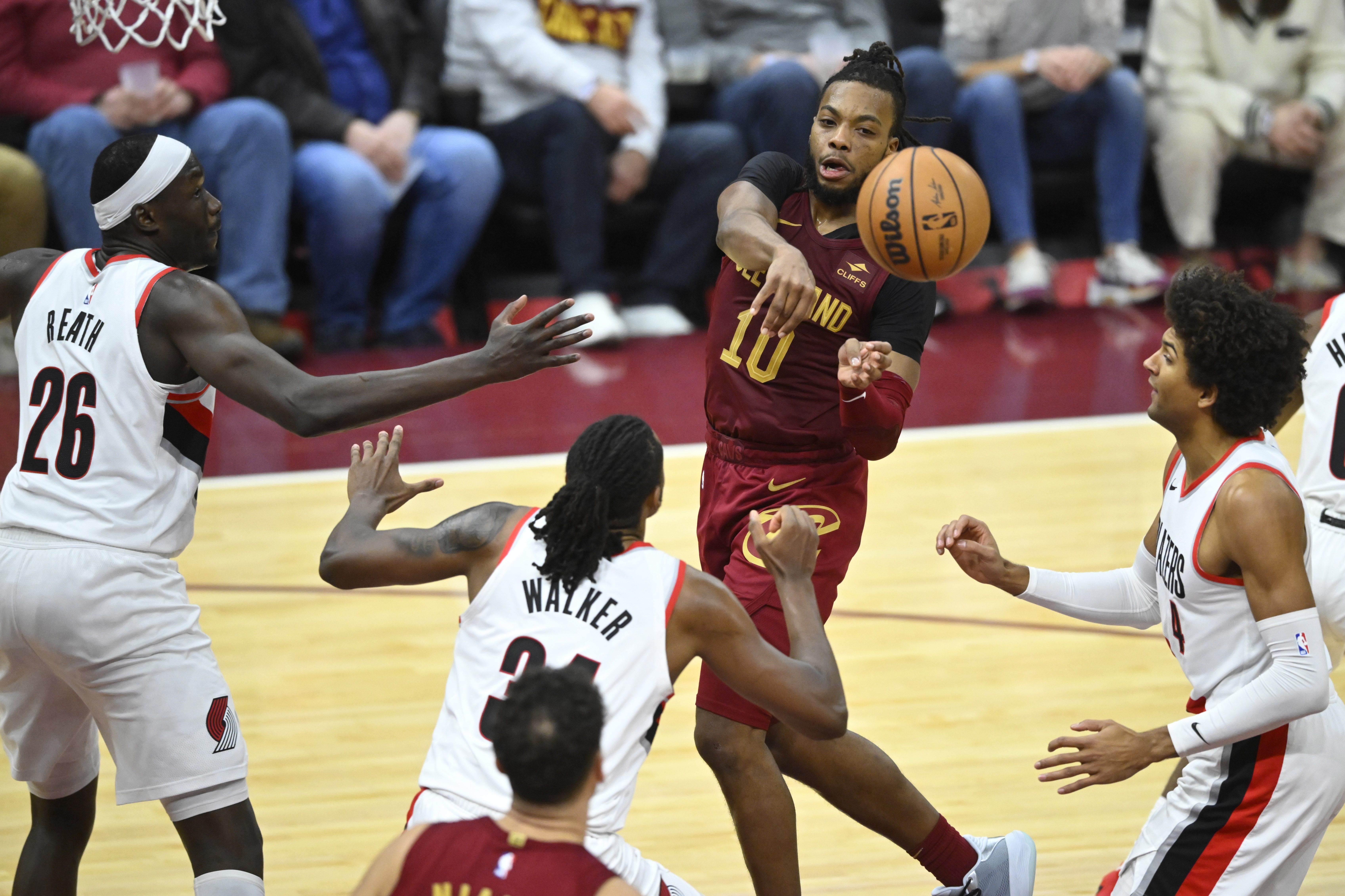 Nov 30, 2023; Cleveland, Ohio, USA; Cleveland Cavaliers guard Darius Garland (10) throws a pass between three Portland Trail Blazers in the fourth quarter at Rocket Mortgage FieldHouse.